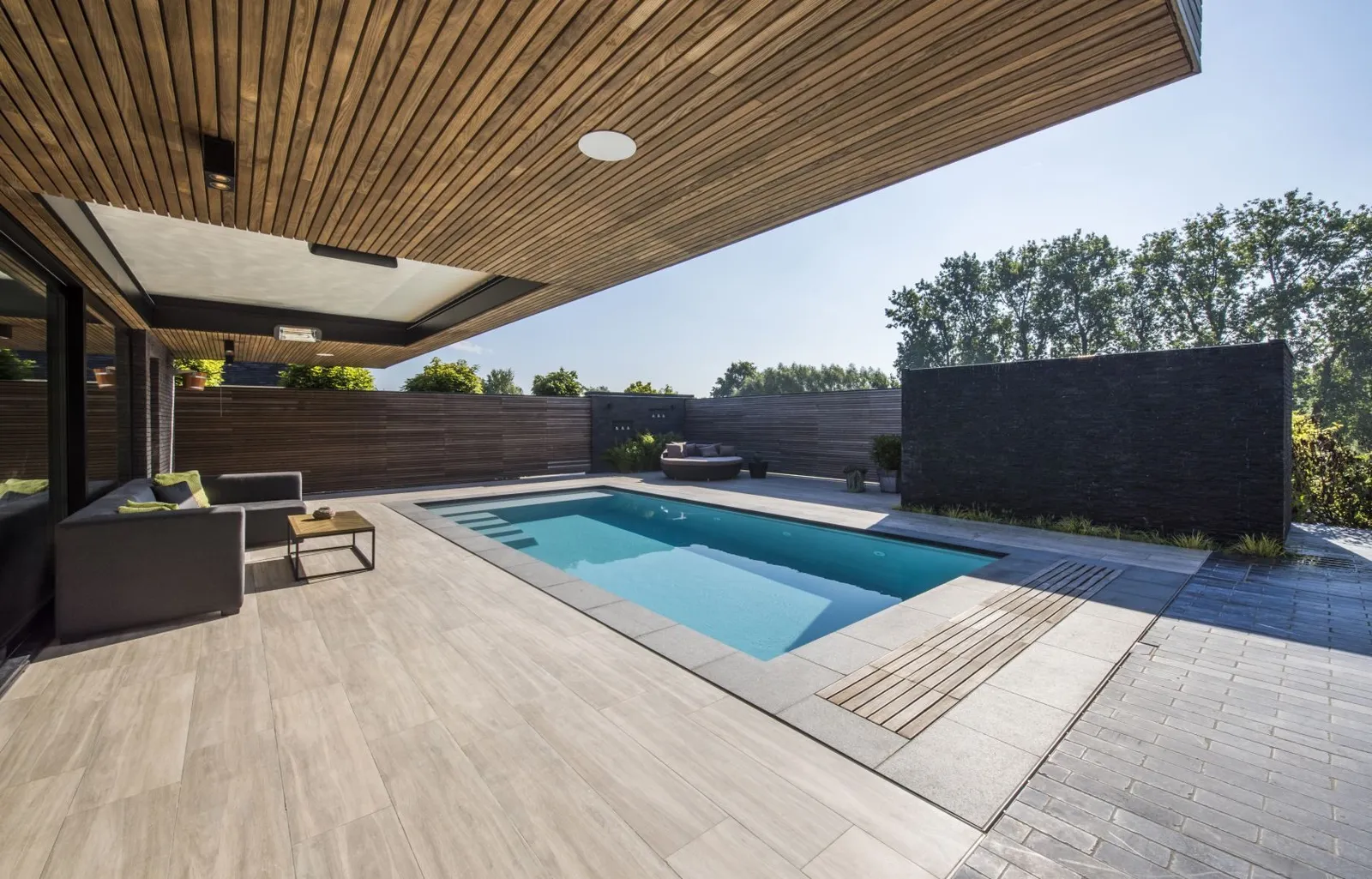 Überdachte Terrasse mit Pool und Blick in den Garten